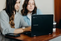 Two women look at laptop. Photo by Brooke Cagle on Unsplash