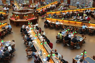 Scene of people studying and reading in a library.